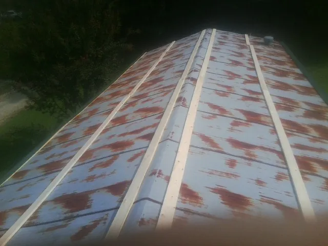 Rusted metal roof panels with new wood purlins before replacement — Storm Damage Roof Repair in Lookout Mountain by Roofing Brothers